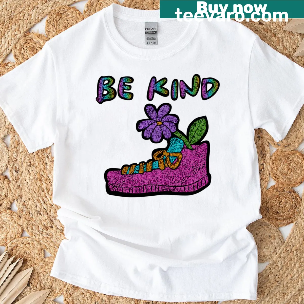 Kindness-themed t-shirt with sneaker and flower squiggle pattern — on a men's t-shirt