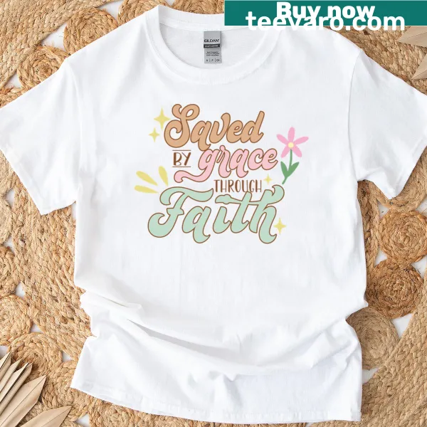 Typographic design featuring the phrase Saved By Grace on a t-shirt