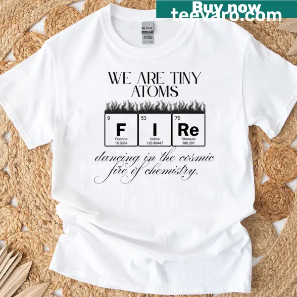 Illustration of tiny dancing atoms surrounded by cosmic fire on a t-shirt.