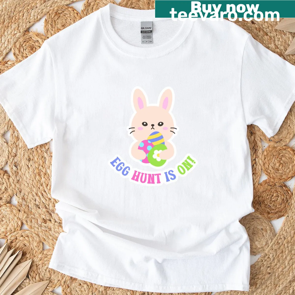 Illustration of an Easter bunny holding eggs and an 'Egg Hunt Is On' banner. — on a men's t-shirt