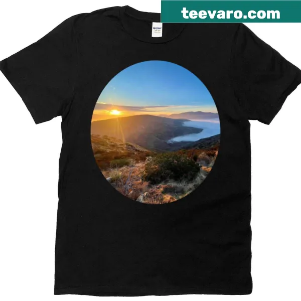 T-shirt featuring an illustration of a sunrise above fog.