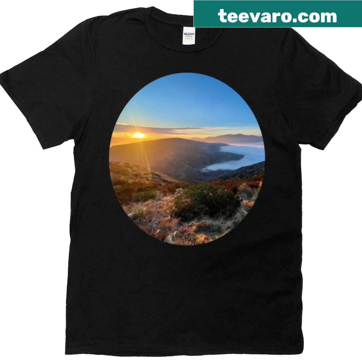 T-shirt featuring an illustration of a sunrise above fog. — on a men's t-shirt