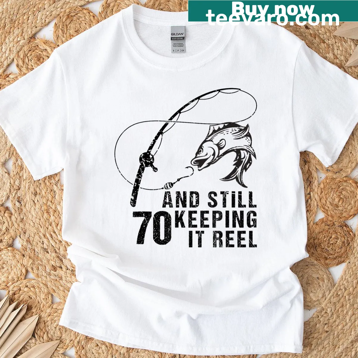 Illustrative fishing shirt celebrating 70 years with playful text — on a men's t-shirt