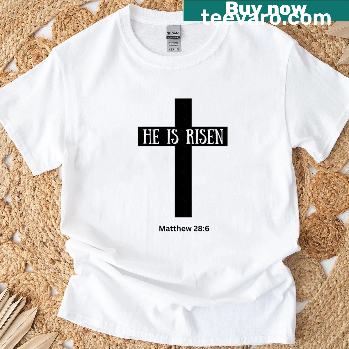 Minimalist t-shirt with a cross and the phrase 'He Is Risen' — on a men's t-shirt