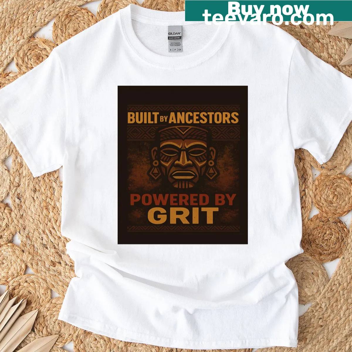 Bold typography t-shirt reading Built By Ancestors Powered By Grit — on a men's t-shirt