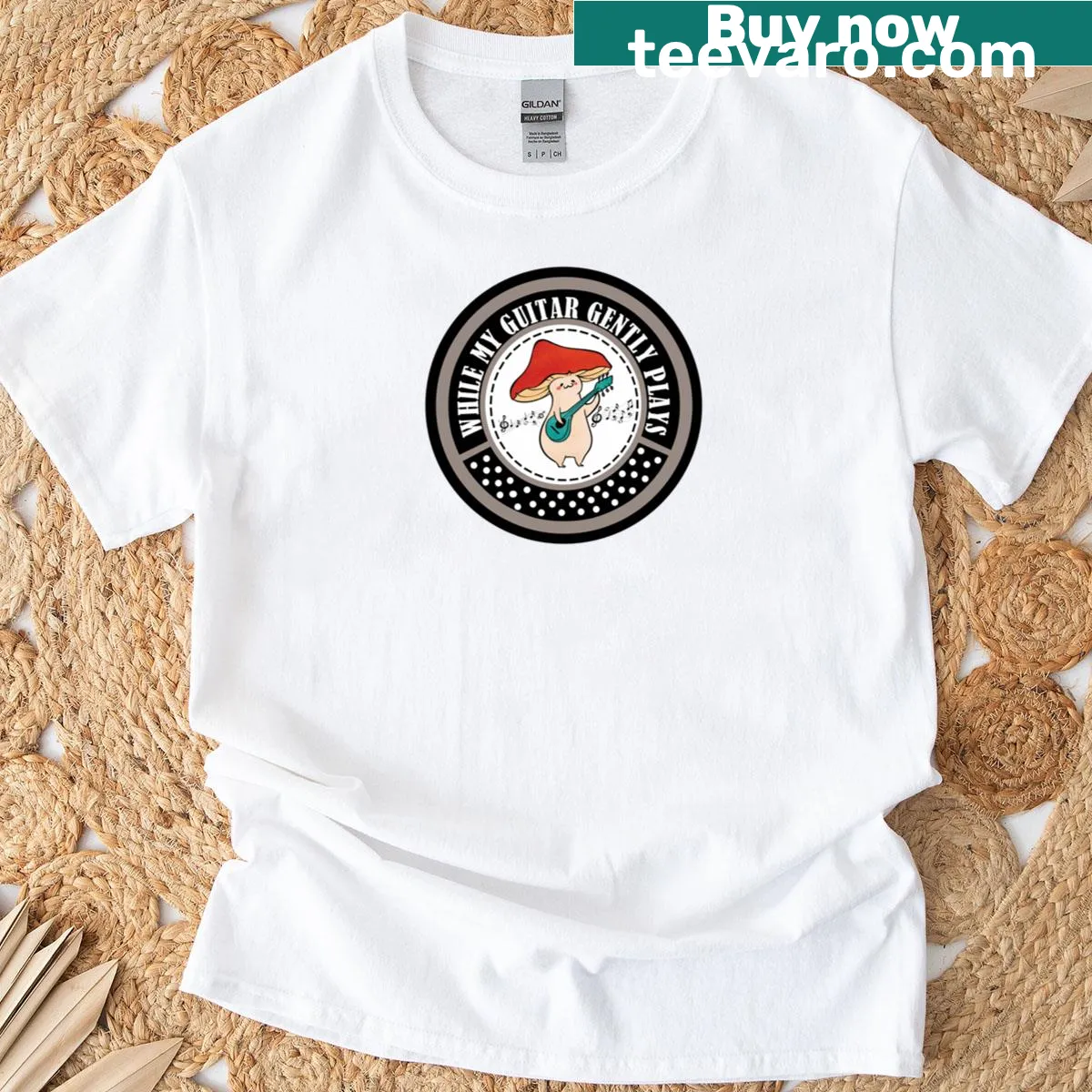 Illustrative T-shirt with While My Guitar Gently Plays phrase — on a men's t-shirt