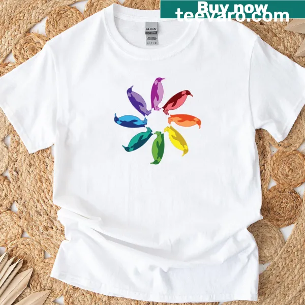 Illustrated T-shirt featuring a colorful emperor penguin and a rainbow pinwheel design.
