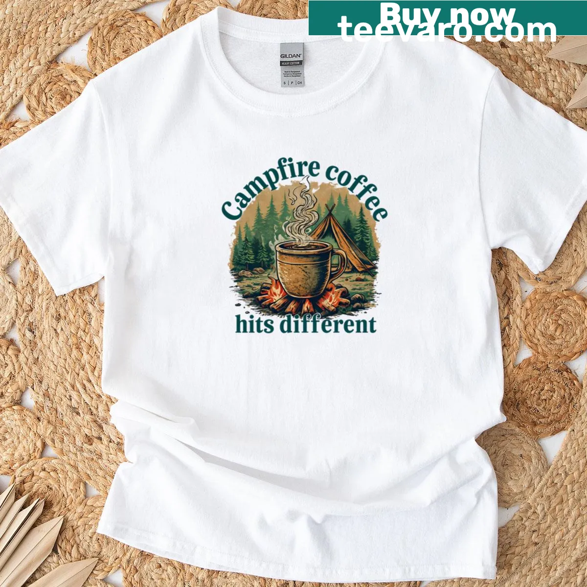 Typography T-shirt featuring the phrase campfire coffee hits different — on a men's t-shirt