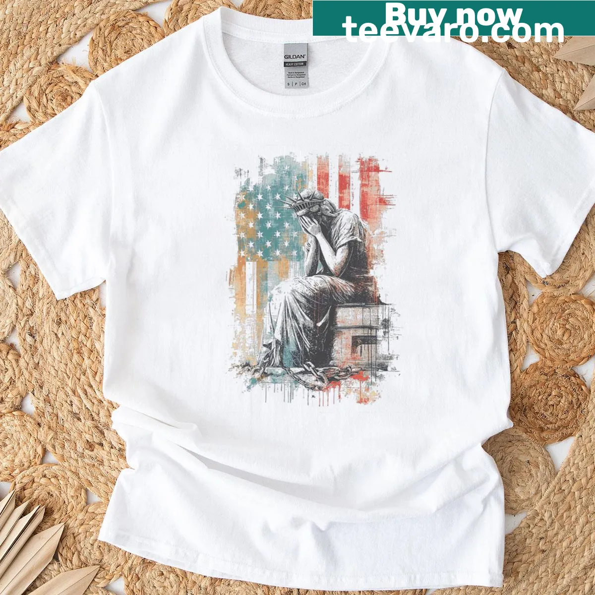 Distressed T-shirt featuring a weeping Statue of Liberty with an American flag background — on a men's t-shirt