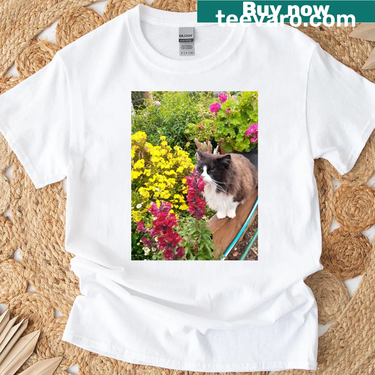 Adorable tuxedo cat sniffing flowers in a beautiful garden design — on a men's t-shirt
