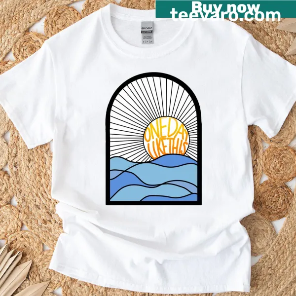 Artistic T-shirt featuring the phrase 'One Day Like This' with a sunrise design