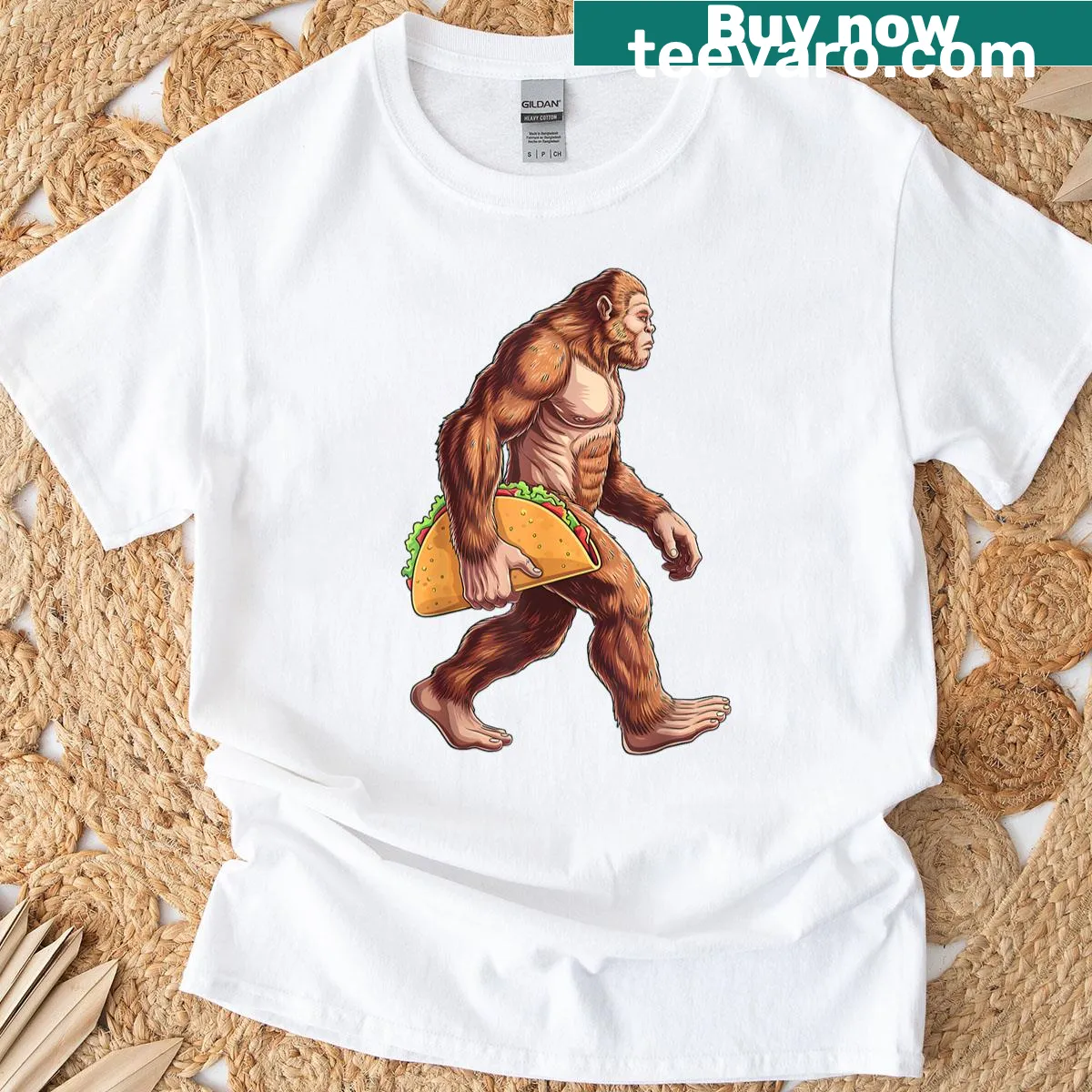 Funny Bigfoot carrying a taco cartoon t-shirt for Cinco de Mayo — on a men's t-shirt