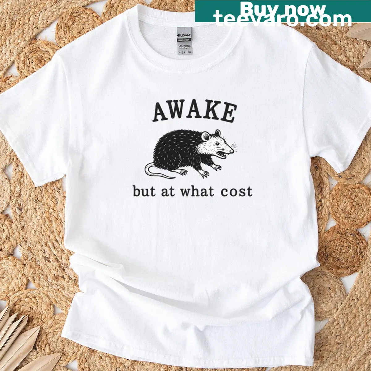Thought-provoking t-shirt with the phrase Awake But At What Cost — on a men's t-shirt