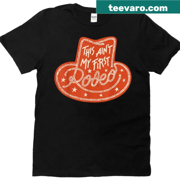 Vintage-style tee with 'This Ain't My First Rodeo' in classic Western lettering.