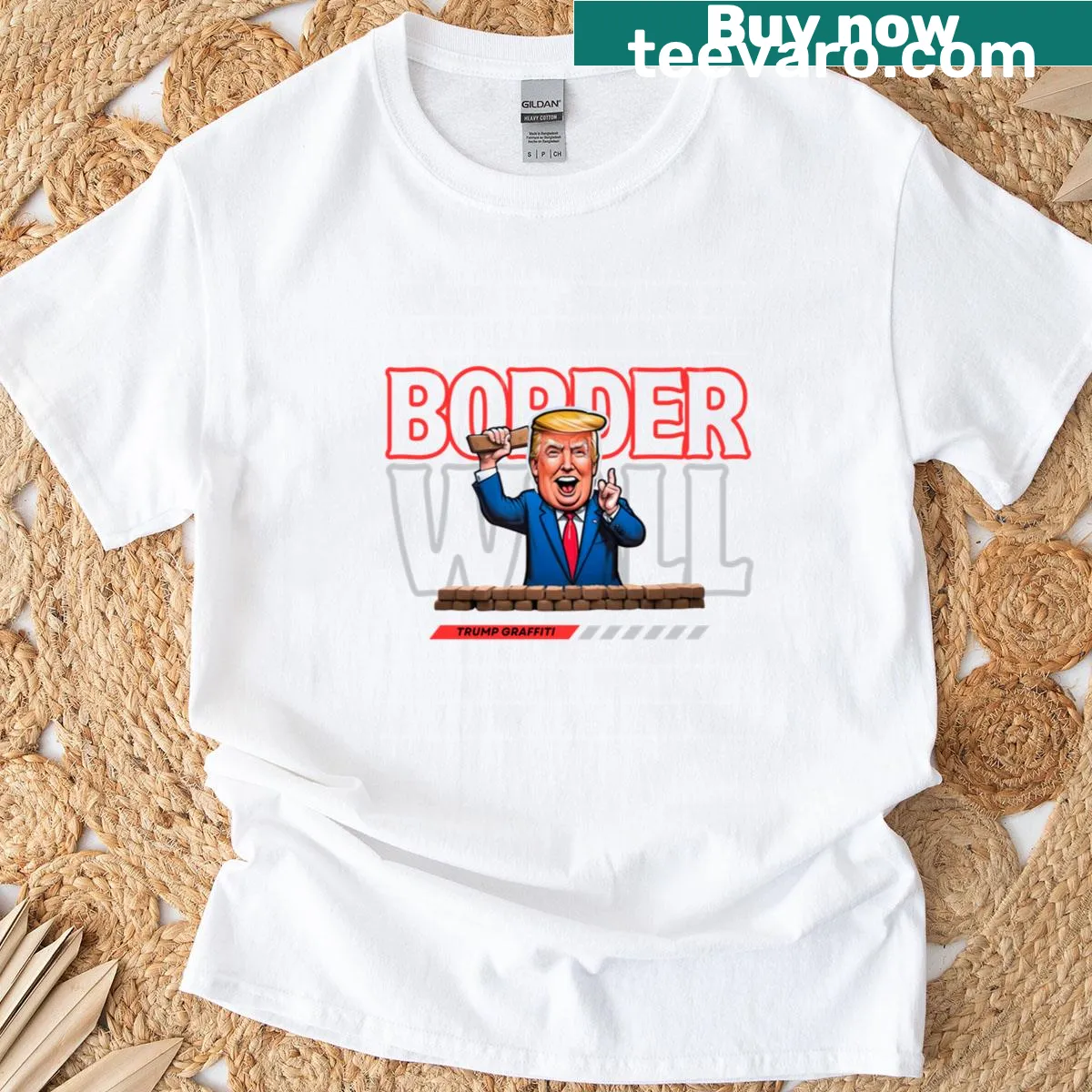 Graffiti-style T-shirt featuring a border wall and Trump text — on a men's t-shirt