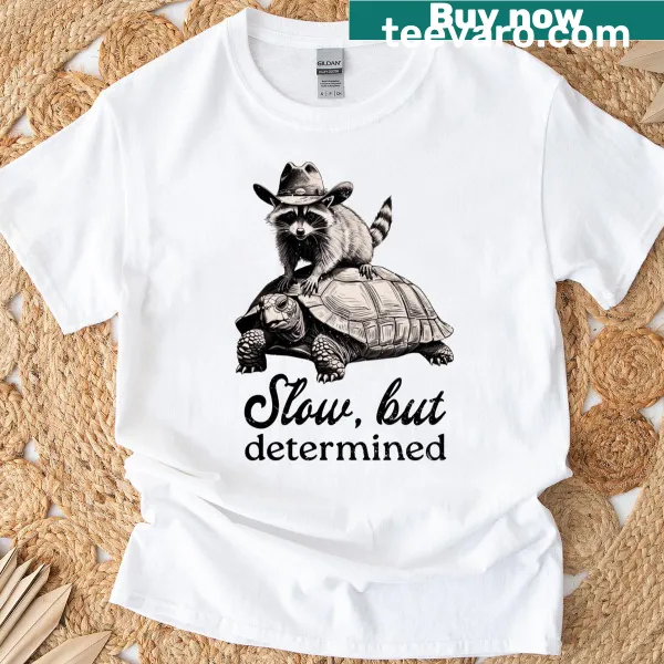 Funny t-shirt featuring a raccoon quote about being slow but determined.