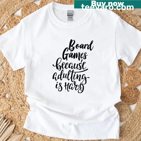 Classic t-shirt with the phrase 'Board Games Because Adulting Is Hard' in playful typography