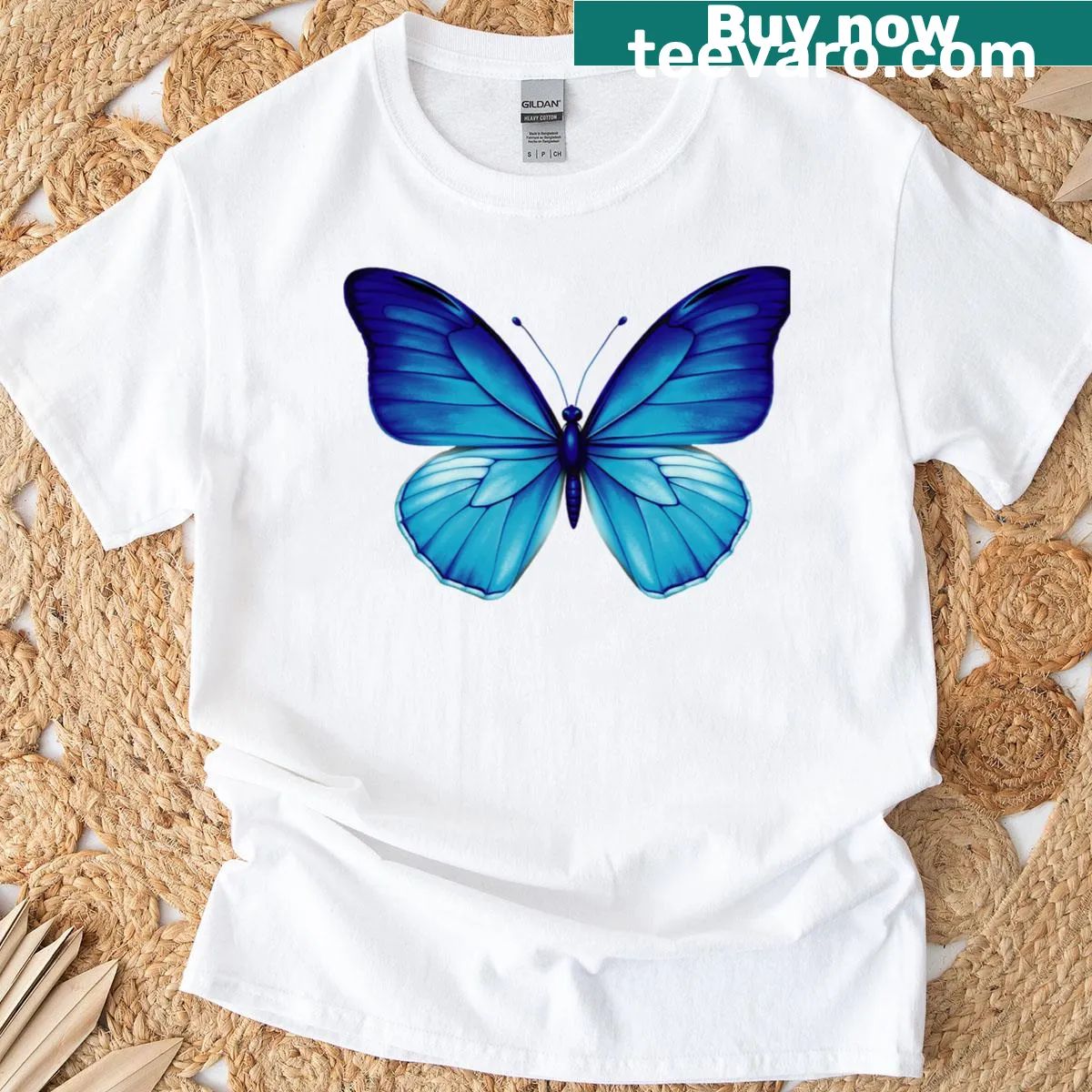 T-shirt featuring an elegant blue butterfly illustration inspired by nature. — on a men's t-shirt