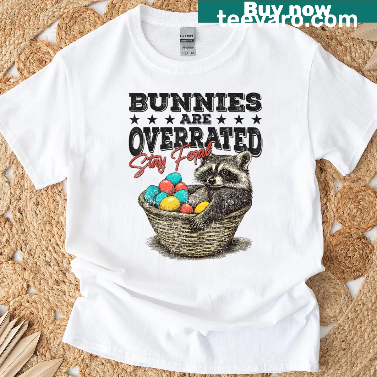 Funny raccoon graphic t-shirt for Easter with Stay Feral message — on a men's t-shirt