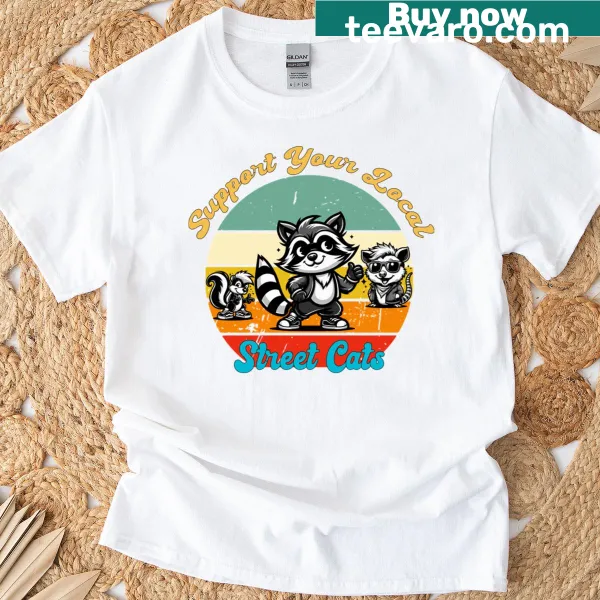 Illustrated T-shirt featuring playful street cats in an urban setting