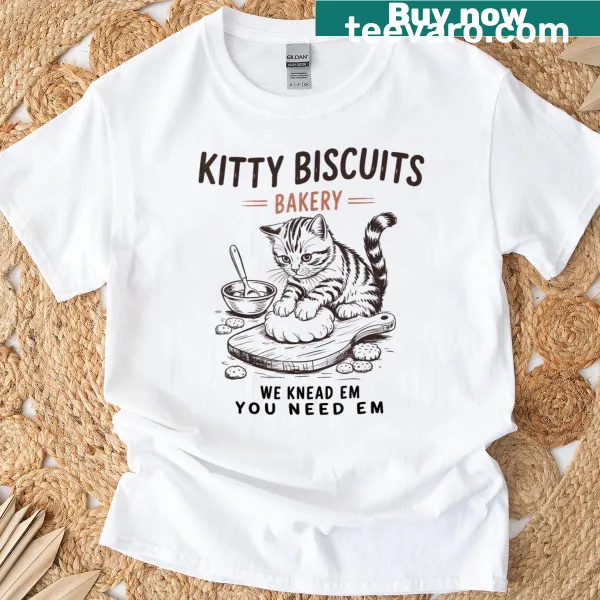 Whimsical T-shirt with the phrase 'We Knead Em You Need Em' for cat lovers.