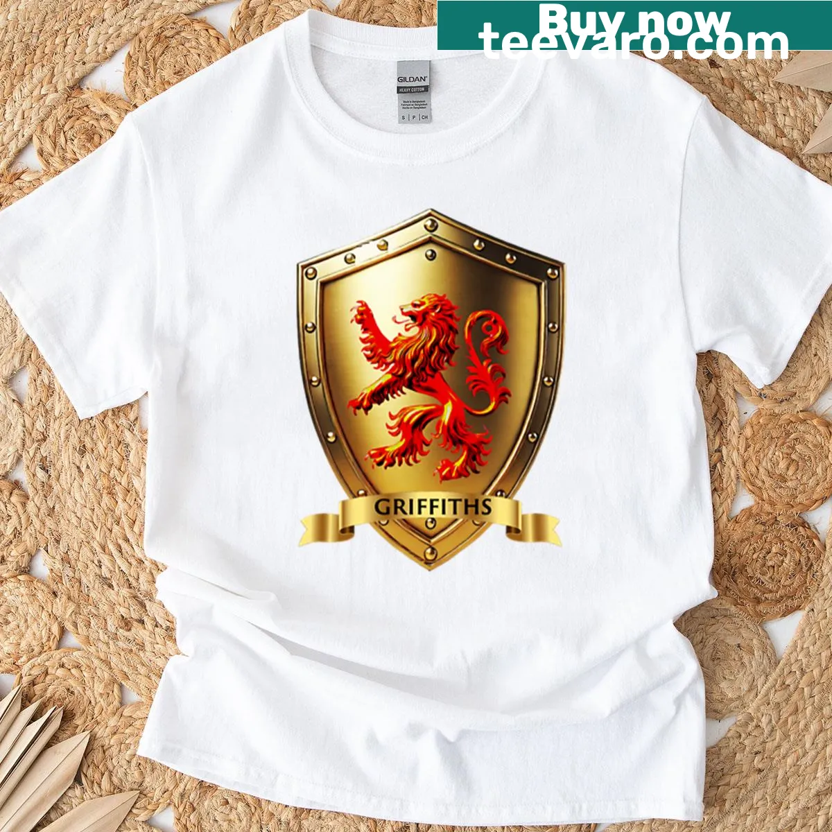 Illustrated family shield T-shirt with a red lion rampant and name banner — on a men's t-shirt