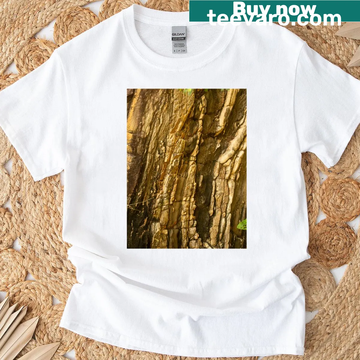 Realistic T-shirt depicting a mountainous formation with shades of brown and gold — on a men's t-shirt