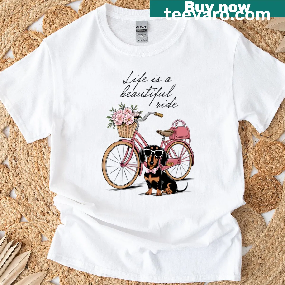T-shirt with a whimsical illustration of a dachshund riding a bike — on a men's t-shirt