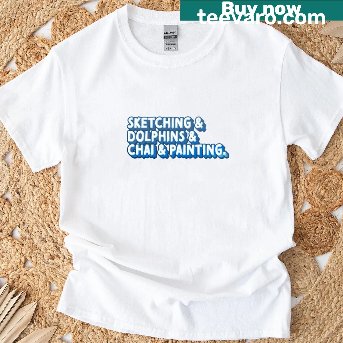 Artistic graphic T-shirt showcasing sketching tools, dolphins, and painting elements — on a men's t-shirt