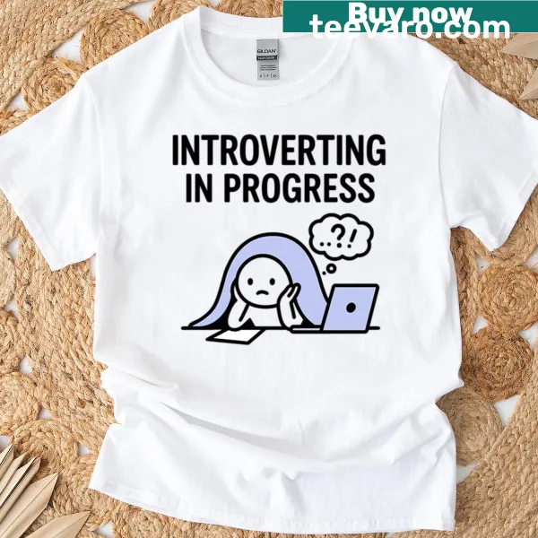 Oversized t-shirt with a cartoon character hiding under a blanket with a laptop