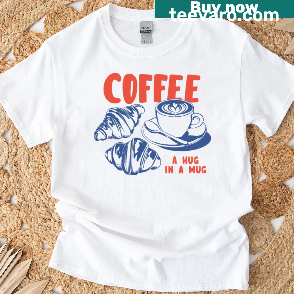 Retro t-shirt featuring coffee and croissant graphics with the phrase 'Coffee A Hug In A Mug' — on a men's t-shirt
