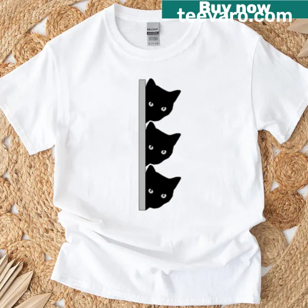 Whimsical t-shirt with multiple cats peeking in different directions