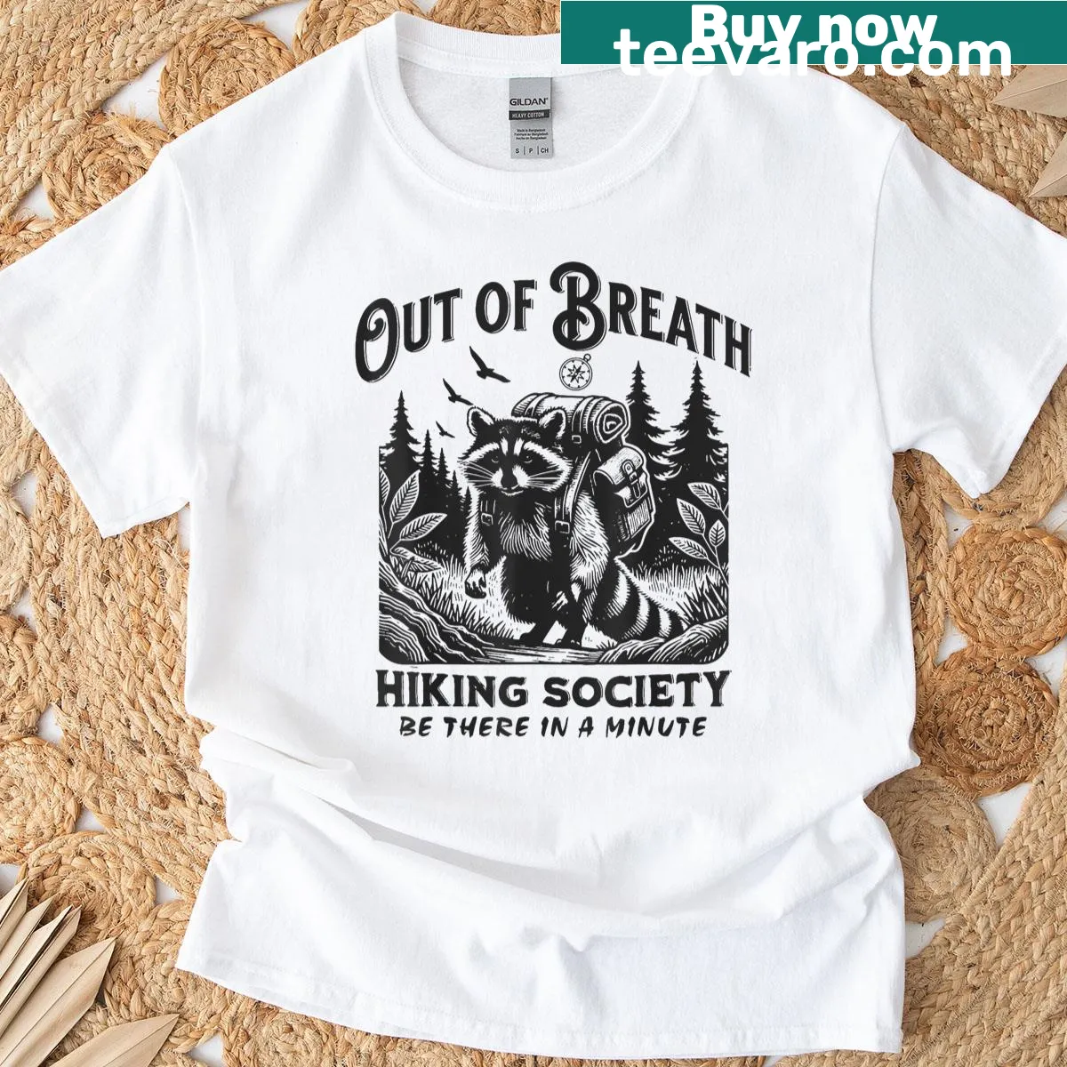 Illustrated t-shirt featuring a raccoon and hiking theme — on a men's t-shirt