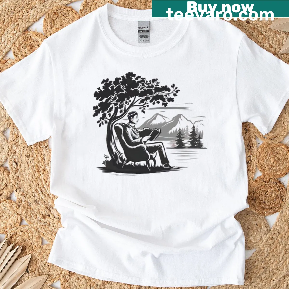 Cozy oversized t-shirt featuring a peaceful outdoor reading scene for book lovers. — on a men's t-shirt