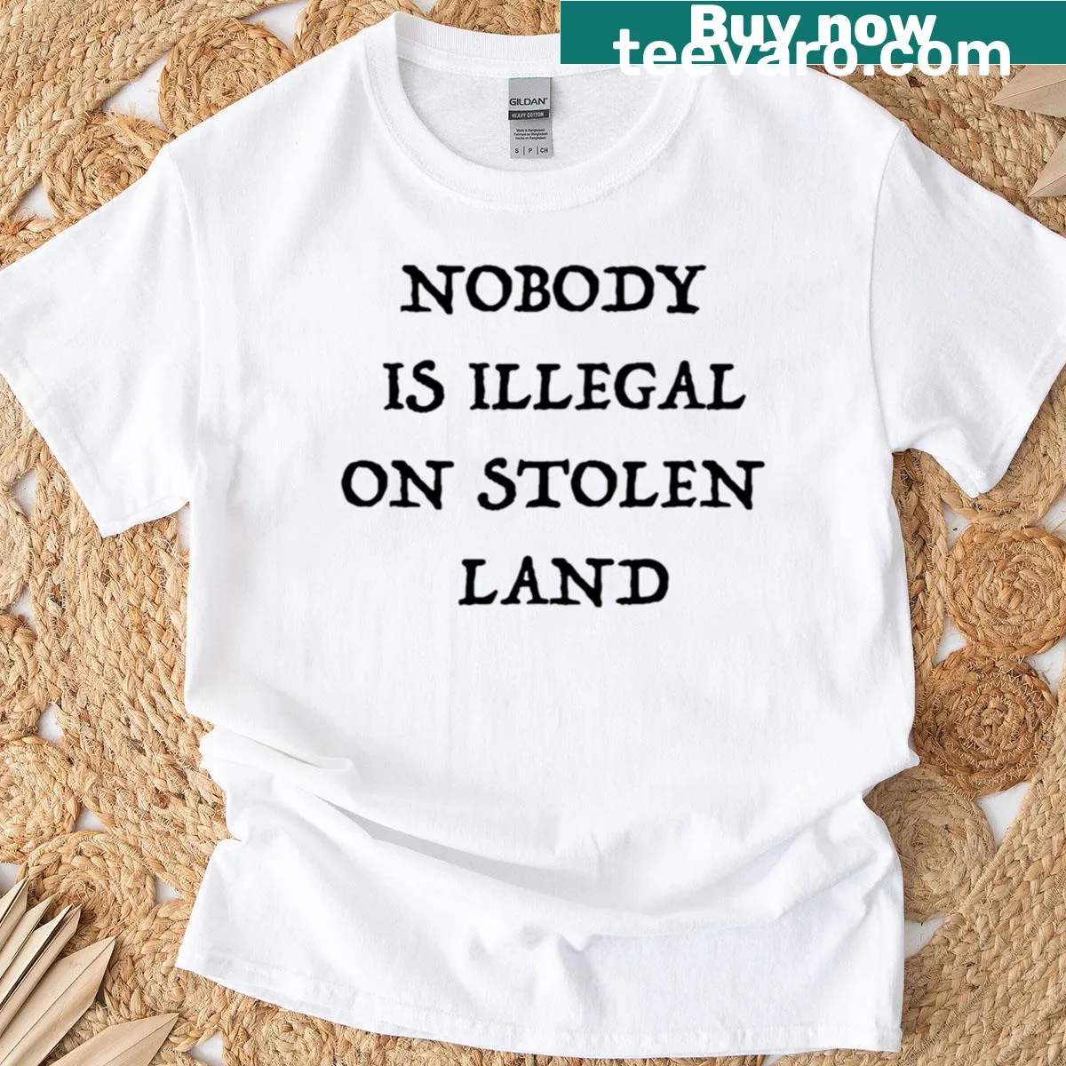Bold t-shirt featuring the phrase 'No One Is Illegal On Stolen Land' — on a men's t-shirt