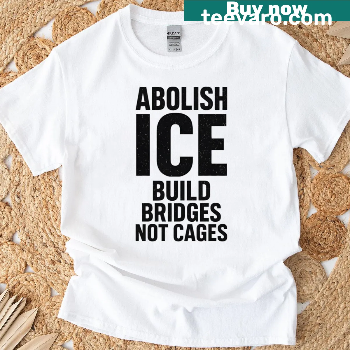 Bold typography T-shirt with the phrase 'Abolish Ice Build Bridges Not Cages' — on a men's t-shirt