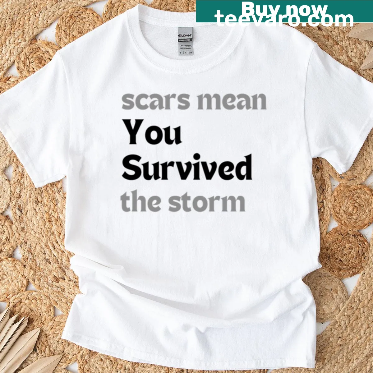 Minimalist T-shirt with the quote 'Scars Mean You Survived The Storm' in modern typography — on a men's t-shirt
