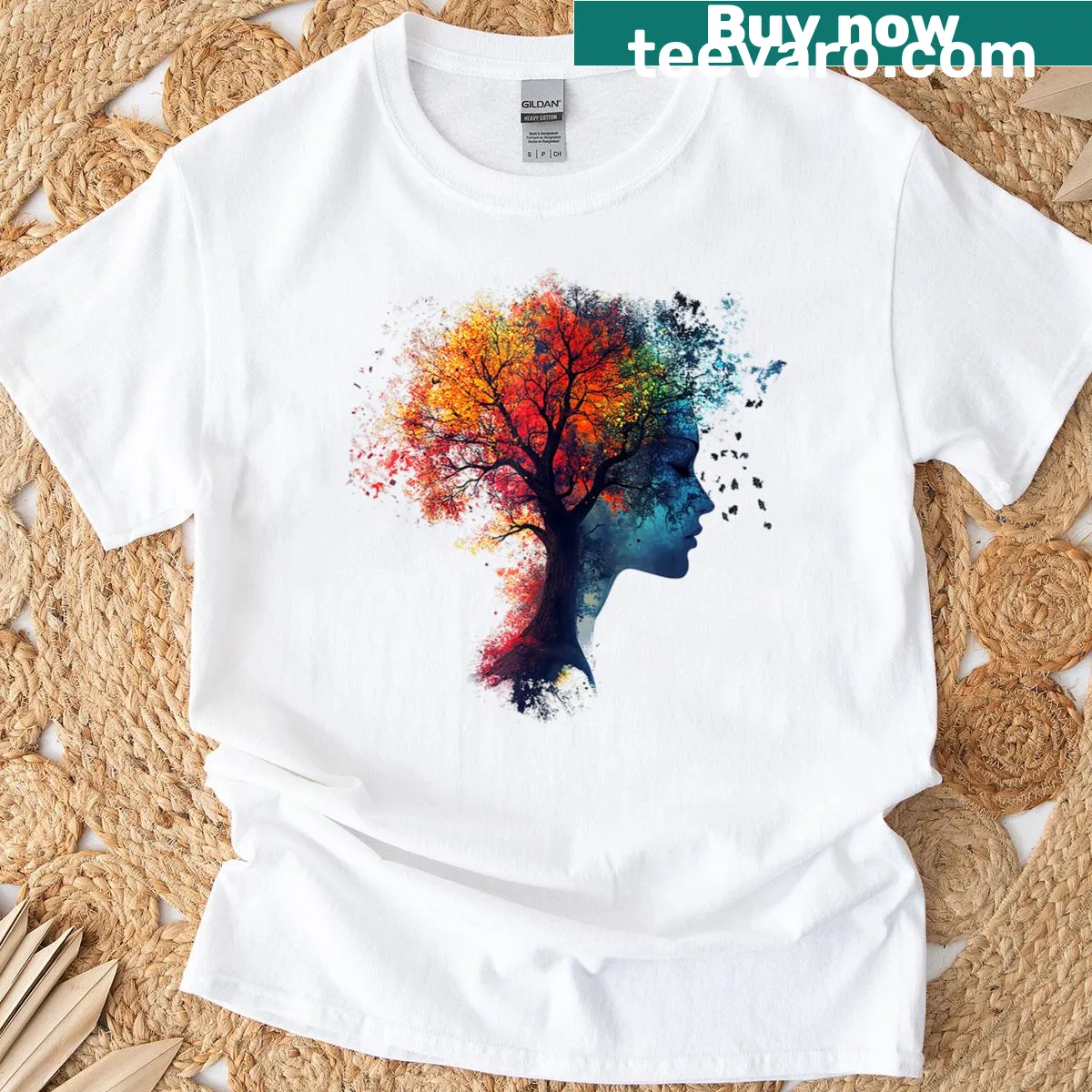 T-shirt featuring an abstract graphic of a woman's face with tree elements — on a men's t-shirt