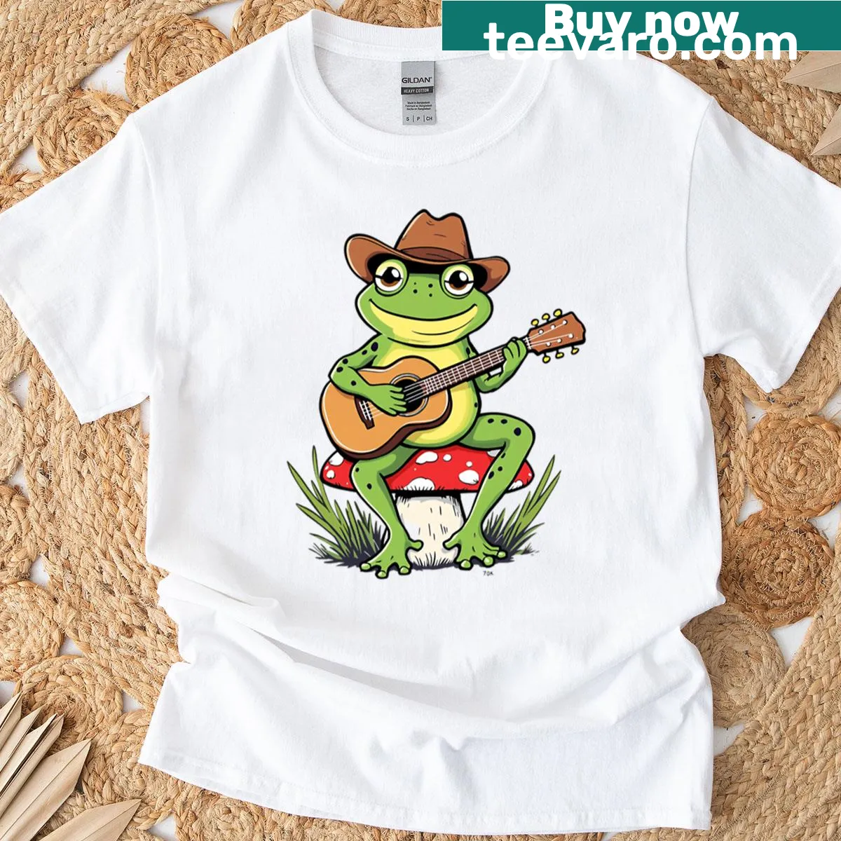 Cute cartoon graphic t-shirt of a frog playing guitar — on a men's t-shirt