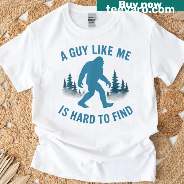 Humorous Bigfoot-themed T-shirt with the phrase 'A Guy Like Me Is Hard To Forest Find'.