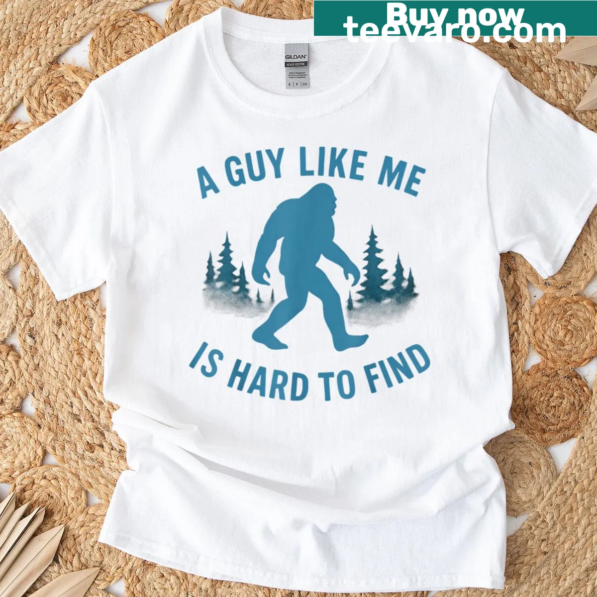 Humorous Bigfoot-themed T-shirt with the phrase 'A Guy Like Me Is Hard To Forest Find'. — on a men's t-shirt
