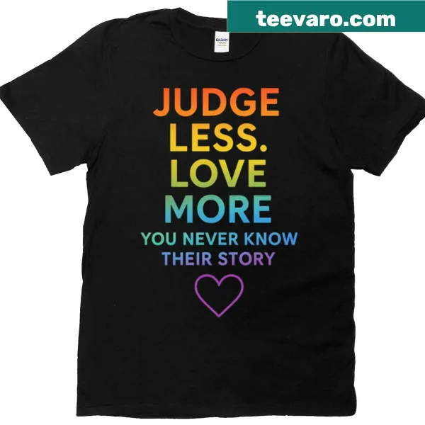 Inspirational tee with quote 'Judge Less Love More' in rainbow design.