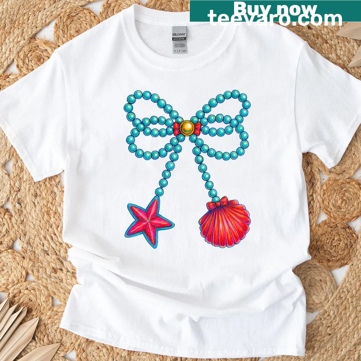 T-shirt featuring an illustrated design of a pearl bow, starfish, and seashells. — on a men's t-shirt