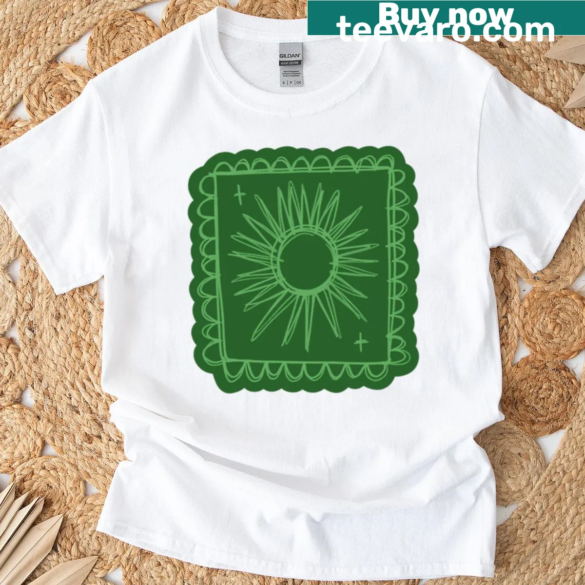Minimalist green sun stamp graphic on a casual T-shirt — on a men's t-shirt