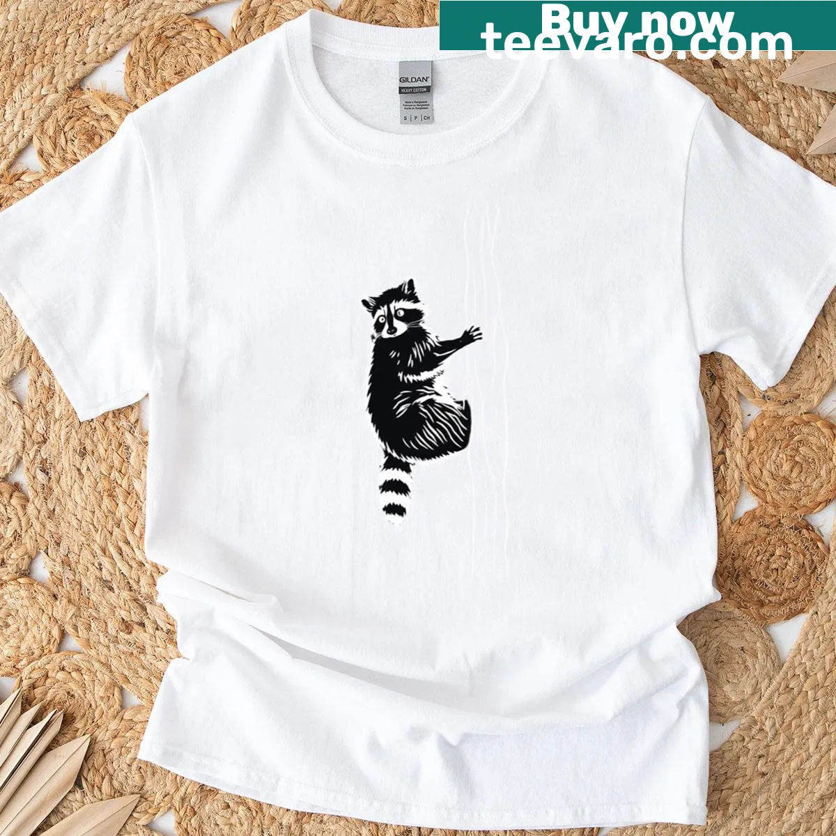 Minimalist t-shirt with a raccoon climbing a tree silhouette. — on a men's t-shirt