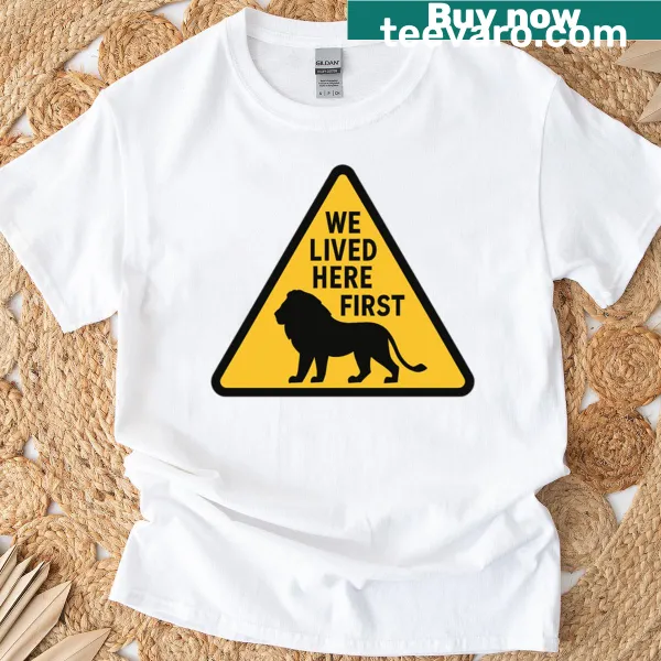 Text 'We Lived Here First' on a casual T-shirt