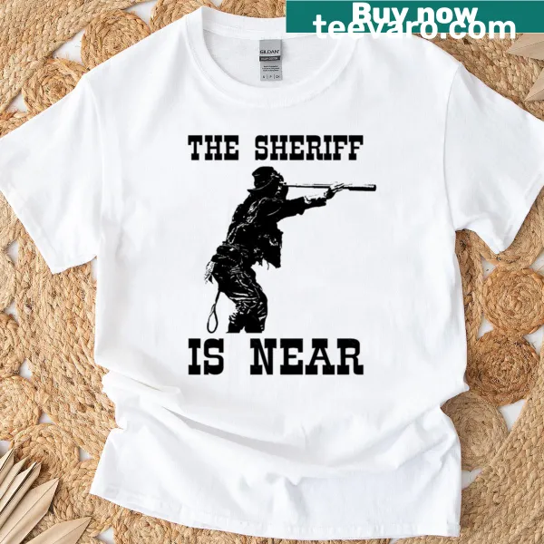 Humorous T-shirt with 'Saddles Sheriff Is Near' text and illustration