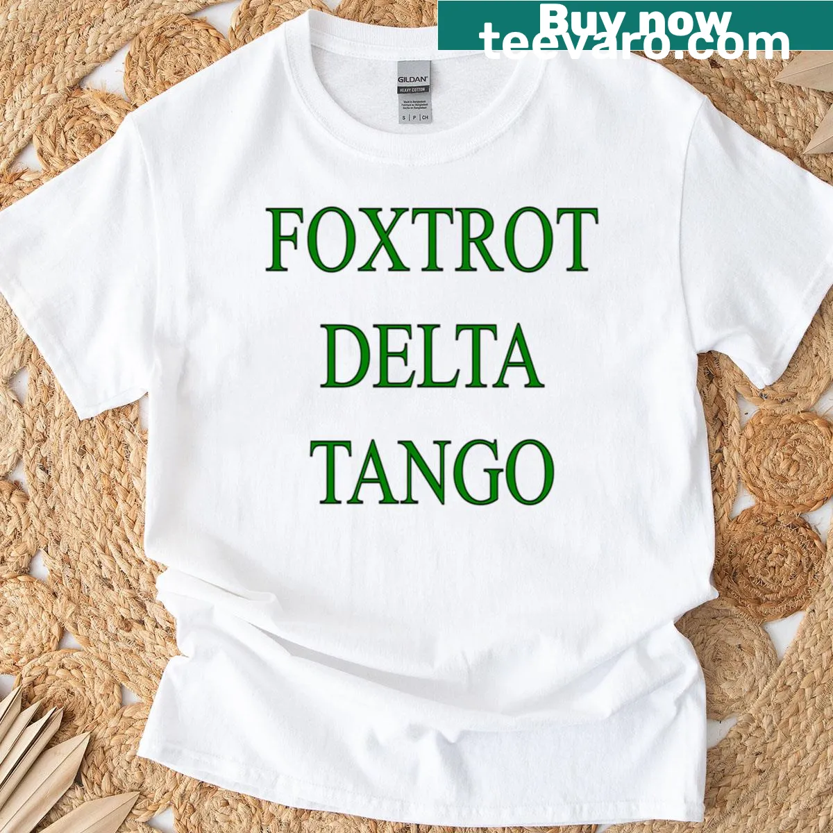Minimalist typography of 'Foxtrot Delta Tango' on green t-shirt — on a men's t-shirt