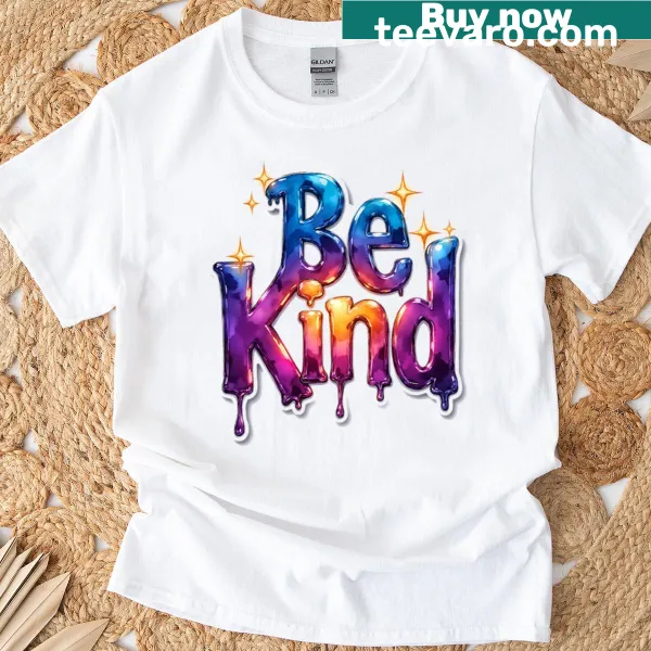 Rainbow drip lettering design with the message 'Be Kind' on a t-shirt.