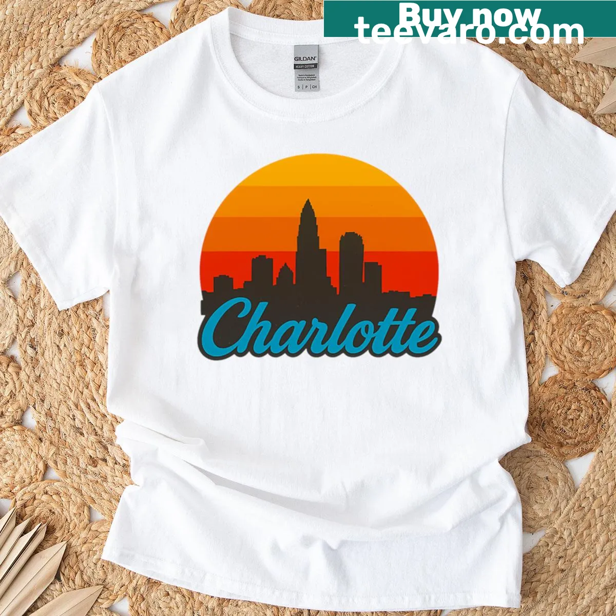 Silhouette of Charlotte skyline against a sunset on a T-shirt — on a men's t-shirt